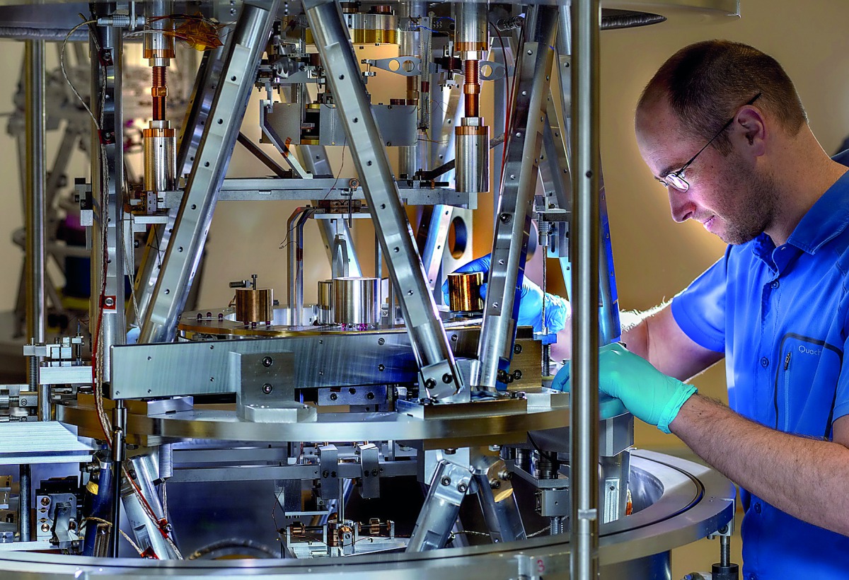 A handout photo taken in 2018 and made available on November 12, 2018, by the Bureau International des Poids et Mesures (BIPM) in Sevres on the western outskirts of Paris shows a scientist at work on the kibble balance, an electromechanical weight measuri