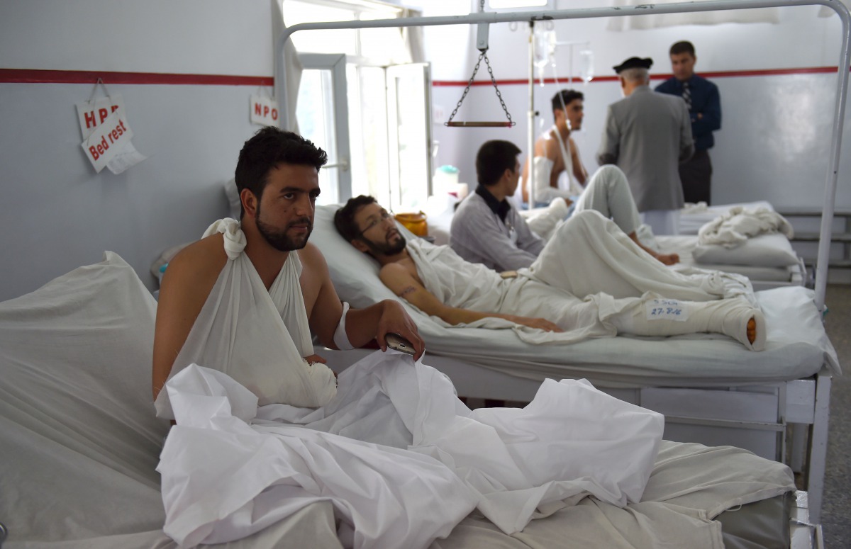 A wounded Afghan police man looks on as he receives treatment following the militants raid that targeted the American University of Afghanistan on August 25, 2016. AFP