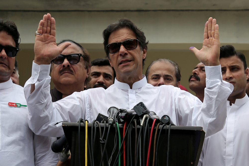 Pakistan Tehreek-e-Insaf chairman Imran Khan speaks to media after casting his vote at a polling station during the general election in Islamabad Pakistan July 25, 2018. Reuters/Athit Perawongmetha.