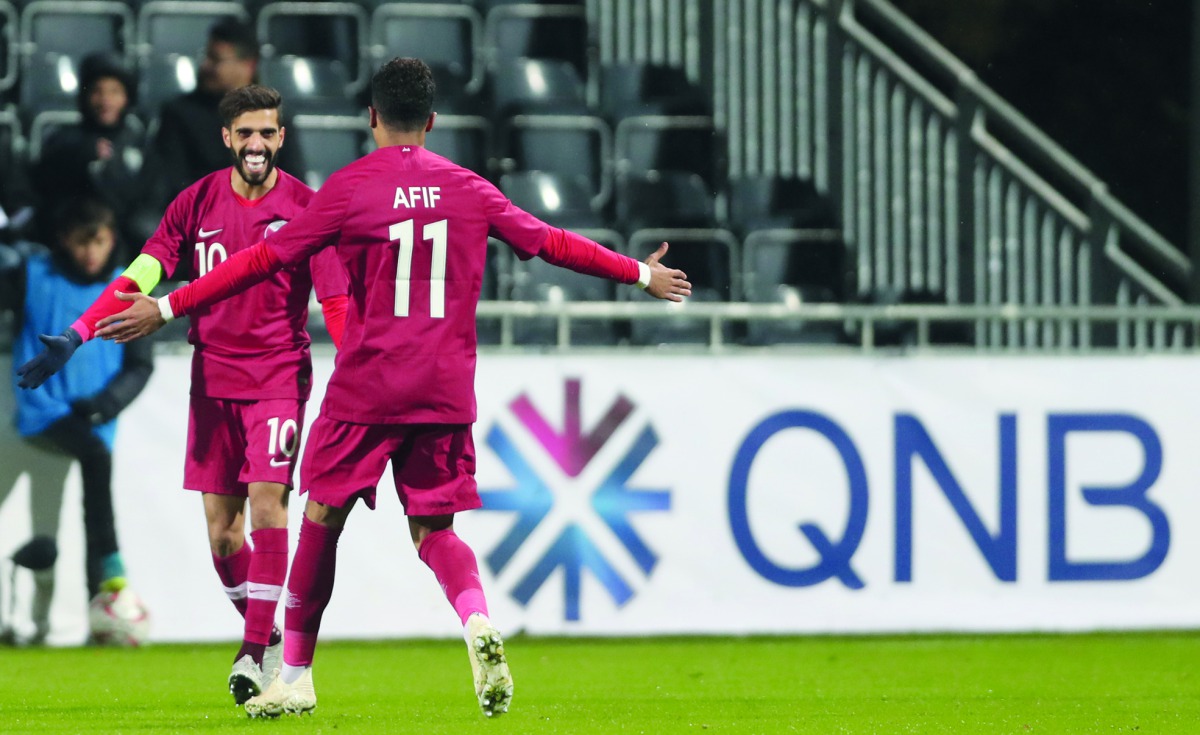 Qatar skipper Hassan Al Haydos celebrates with team-mate Akram Afif after scoring the opening goal in yesterday’s match against Iceland.