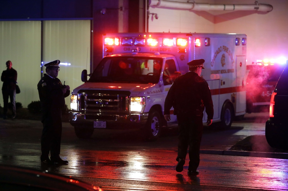 Chicago police officers stand outside the University of Chicago Hospital as the ambulance bearing the body of Chicago police officer Samuel Jimenez is escorted to the morgue November 19, 2018 in Chicago, Illinois. Joshua Lott/Getty Images/AFP
 