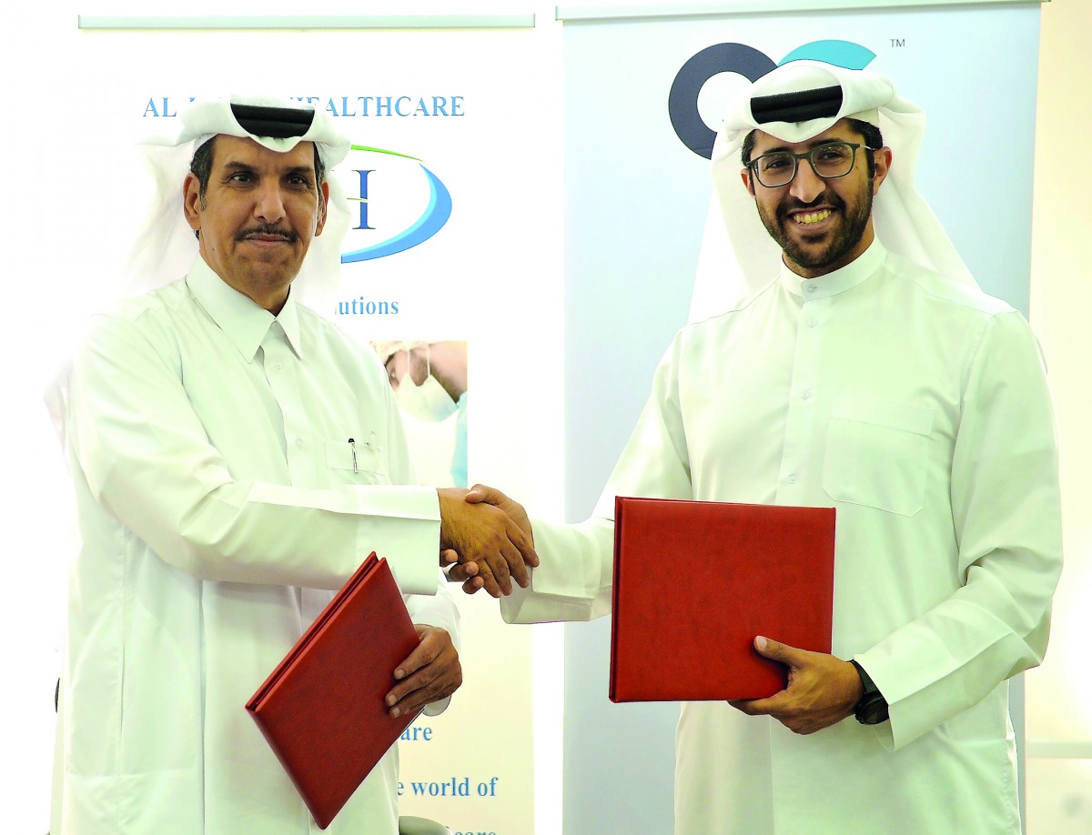 Mohamed Al Hajiri (left), CEO of Al-Jazira Healthcare Group, and Saleh Majid Al Khulaifi, Board Member of Qatari German Medical Devices, exchanging documents after they signed a cooperation agreement in the field of medical manufacturing at a function hel