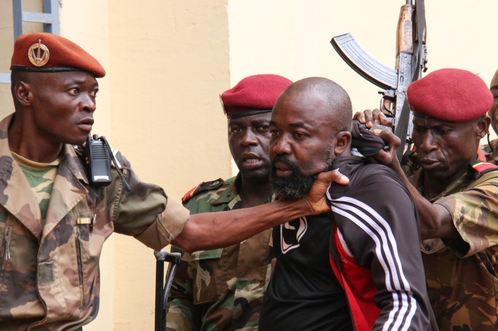 Members of the armed forces arrest on October 29, 2018 Central African MP Alfred Yekatom who represents the southern M'baiki district former militia leader, after he fired the gun at the parliament in Bangui.  AFP / Gael Grilhot 