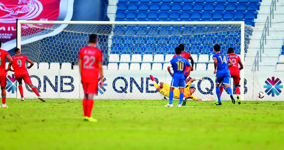 Al Duhail’s Youssef El Arabi (left) scores their winning goal against Al Arabi yesterday.