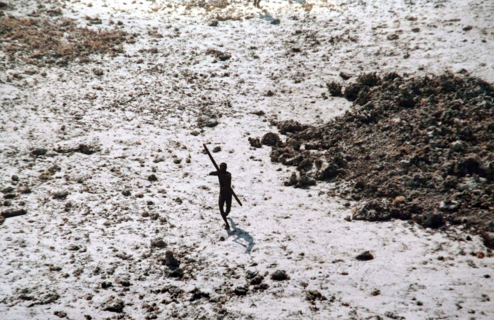 In this handout photo provided by the Indian Coast Guard and Survival International and taken on December 28, 2004, a man with the Sentinelese tribe aims his bow and arrow at an Indian Coast Guard helicopter as it flies over North Sentinel Island in the A