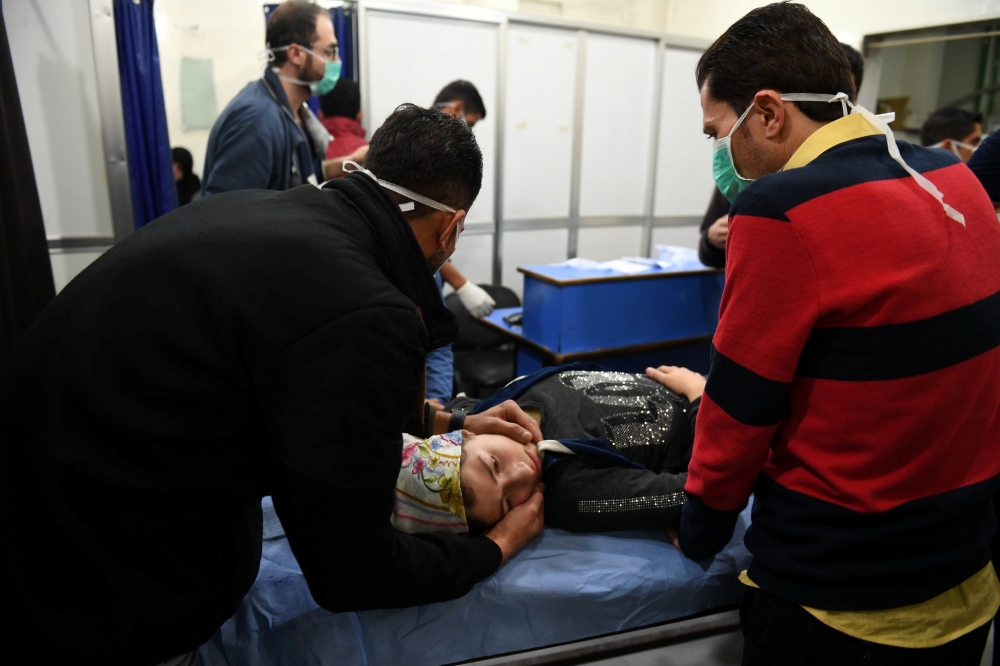 A woman lies on a stretcher inside a hospital after what the Syrian state media said was a suspected toxic gas attack in Aleppo, Syria November 24, 2018. Picture taken November 24, 2018. SANA