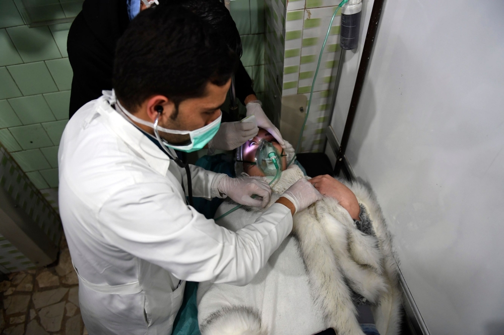 A Syrian woman receives treatment at a hospital in the regime-controlled Aleppo on November 24, 2018.  AFP / George OURFALIAN