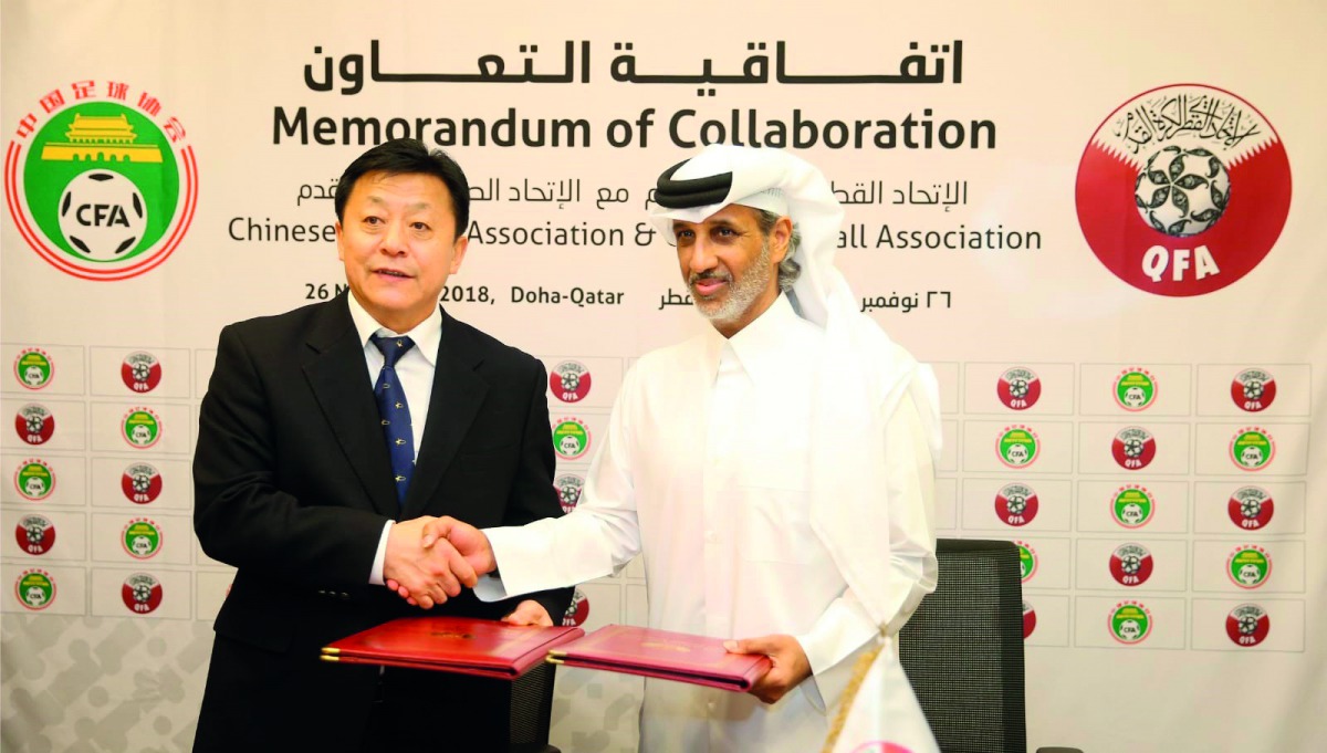 Qatar Football Association (QFA) President Sheikh Hamad bin Kahlifa bin Ahmed Al Thani and Du Zhaocai, Vice Sports Minister of China and CFA Acting President exchange documents during the signing ceremony in Doha yesterday.