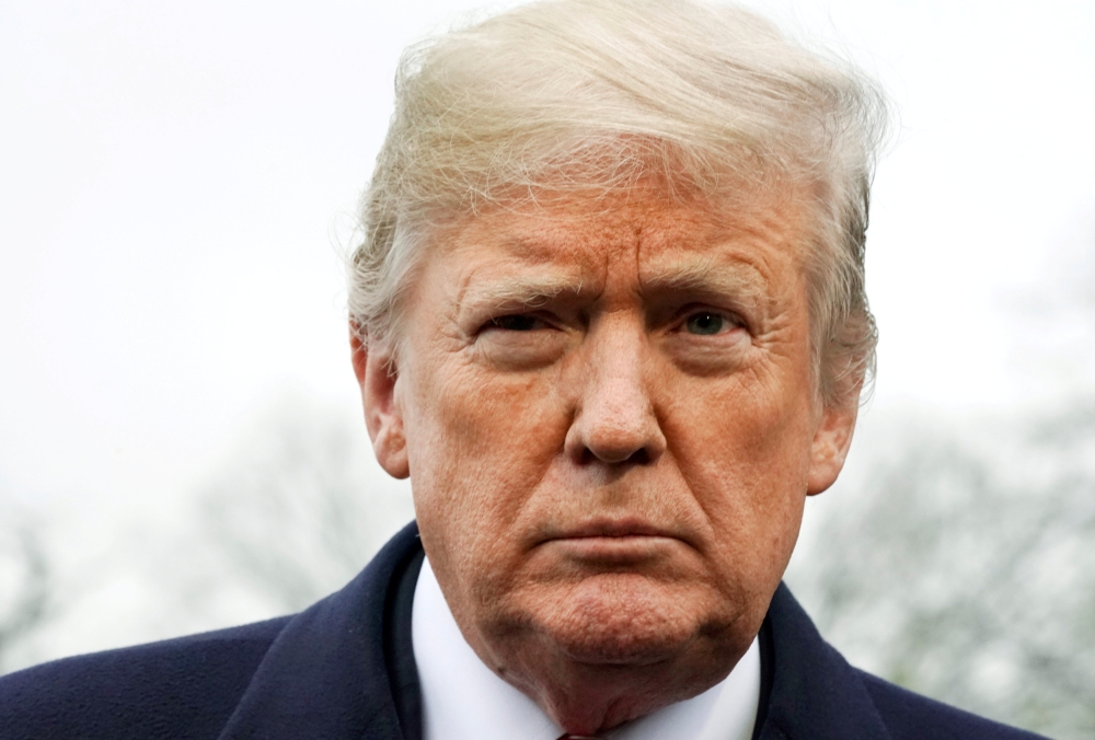 FILE PHOTO: US President Trump talks to reporters as he departs the White House for travel to Mississippi in Washington, U.S. November 26, 2018. REUTERS/Jonathan Ernst/File Photo