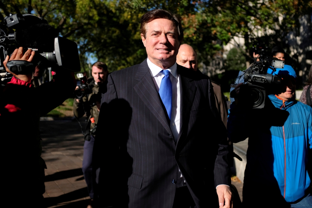 FILE PHOTO: Former Trump 2016 campaign chairman Paul Manafort leaves U.S. Federal Court after being arraigned on twelve federal charges in the investigation into alleged Russian meddling in the 2016 U.S. presidential election in Washington, U.S. October 3