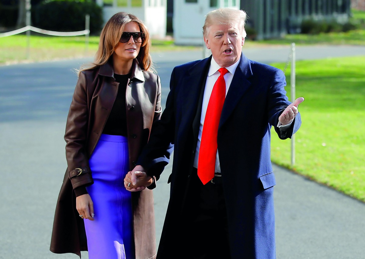 US President Donald Trump talks to reporters with first lady Melania Trump as they depart for travel to the G-20 summit in Argentina from the White House in Washington, U.S., November 29, 2018. Reuters/Jim Young 
