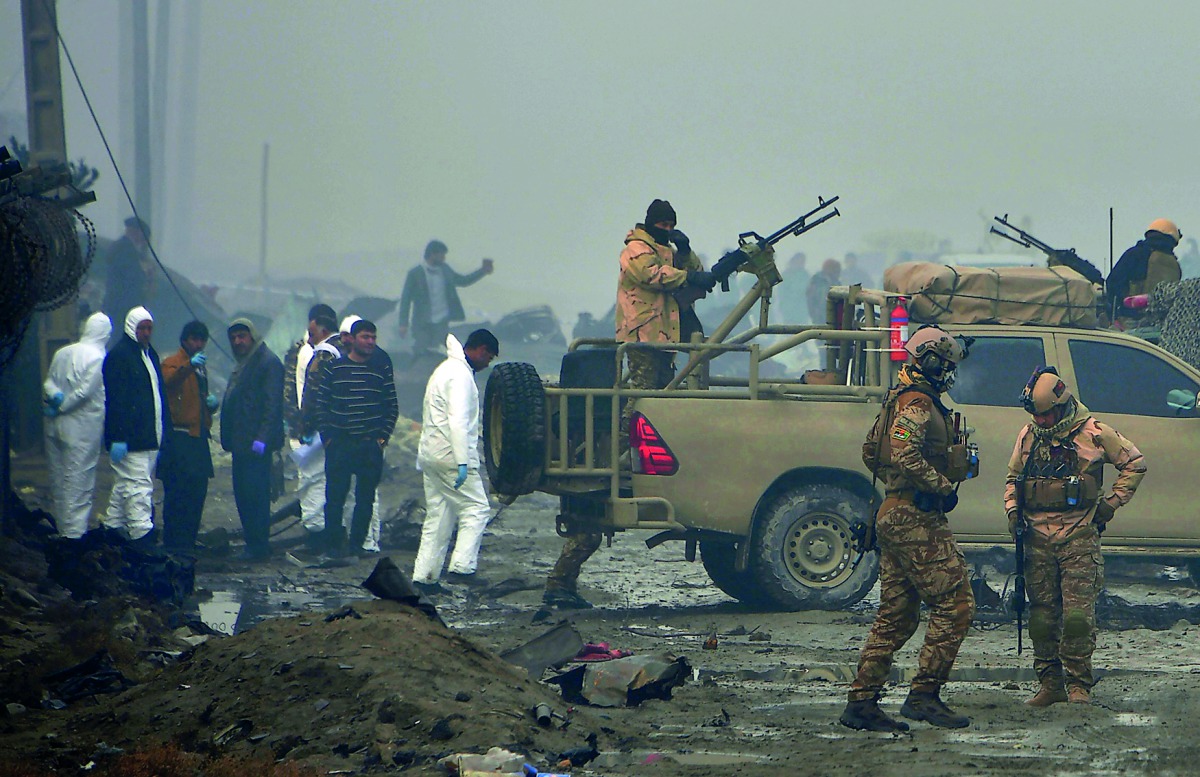 Afghan security forces and investigators gather at the site of a suicide bomb attack outside a British security firm's compound in Kabul, a day after the blast on November 29, 2018.  AFP / Noorullah Shirzada

