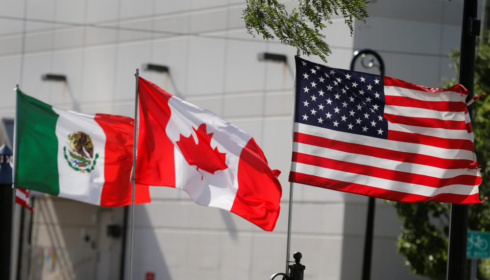 File photo of the flags of US, Canada and Mexico fly next to each other in Detroit, Michigan, US, August 29, 2018. REUTERS/Rebecca Cook/File Photo