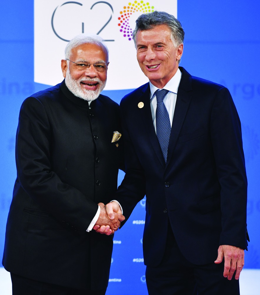 India's Prime Minister Narendra Modi (L) is welcomed by Argentina's President Mauricio Macri at Costa Salguero in Buenos Aires during the G20 Leaders' Summit, on November 30, 2018.  AFP / Alexander Nemenov