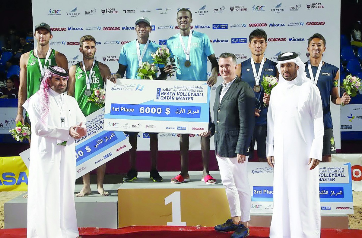 Qatar’s Cherif Younousse and Ahmed Tijan Janko (centre) pose on the podium after winning the AVC Aspire Beach Volleyball Qatar Master 2018 title at Aspire Park, yesterday. Silver medalists Cole Durant and Damien Schumann (left) of Australia, and Japan’s b