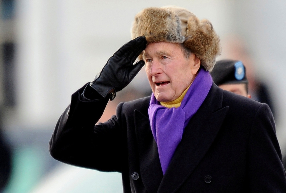 File photo of former U.S. President George H.W. Bush salutes as he departs the East Front of the U.S. Capitol Building after Barack Obama was sworn in as the 44th president of the United States in Washington January 20, 2009. REUTERS/Tannen Maury/Pool/Fil