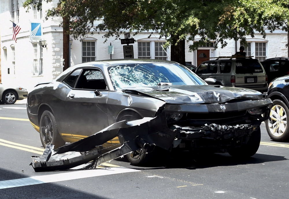 In this file photo taken on August 12, 2017, the Dodge Charger allegedly driven by James Alex Fields Jr. passes near the Market Street Parking Garage moments after driving into a crowd of counter-protesters on Water Street in Charlottesville, Virginia. / 