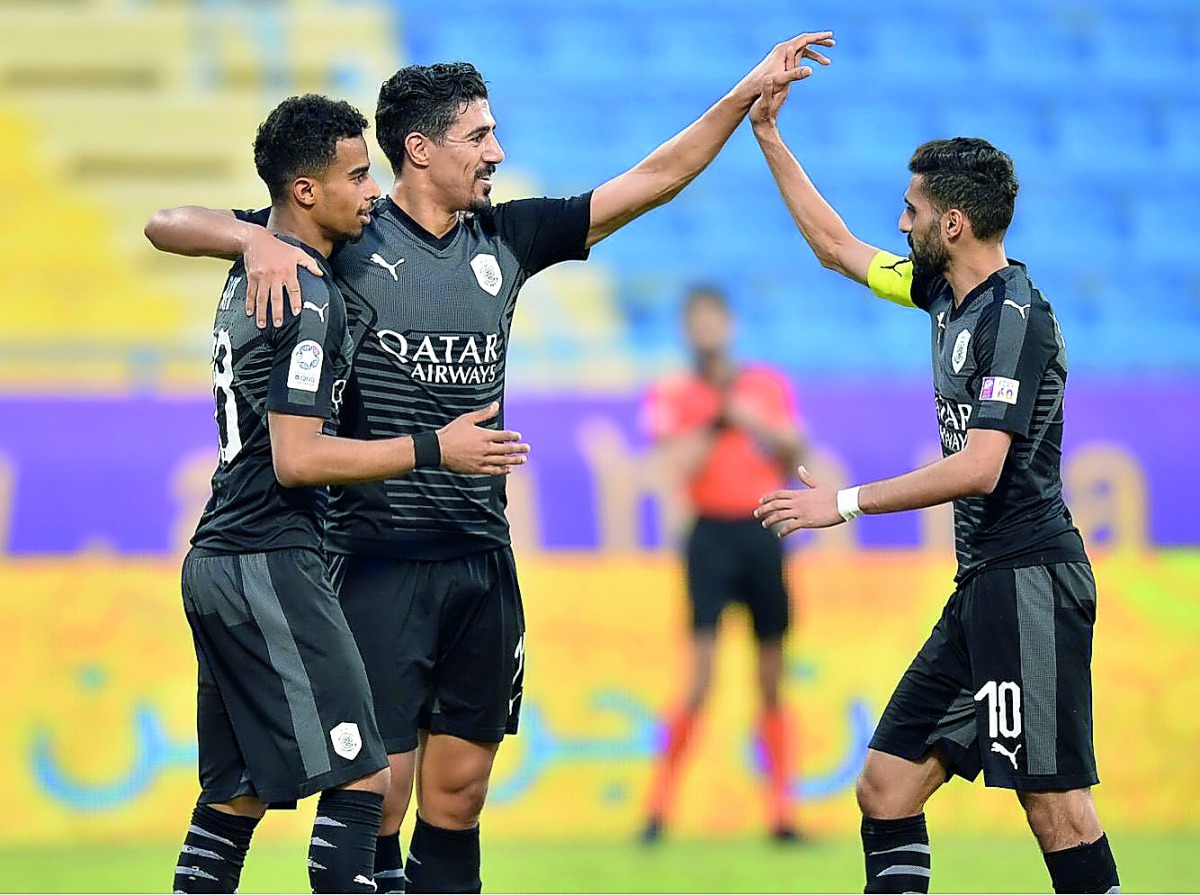 Al Sadd’s Akram Afif, Baghdad Bounedjah and skipper Hassan Al Haydos celebrate after the Algerian striker scored one of his three goals against Al Gharafa at the Al Gharafa Stadium yesterday. 