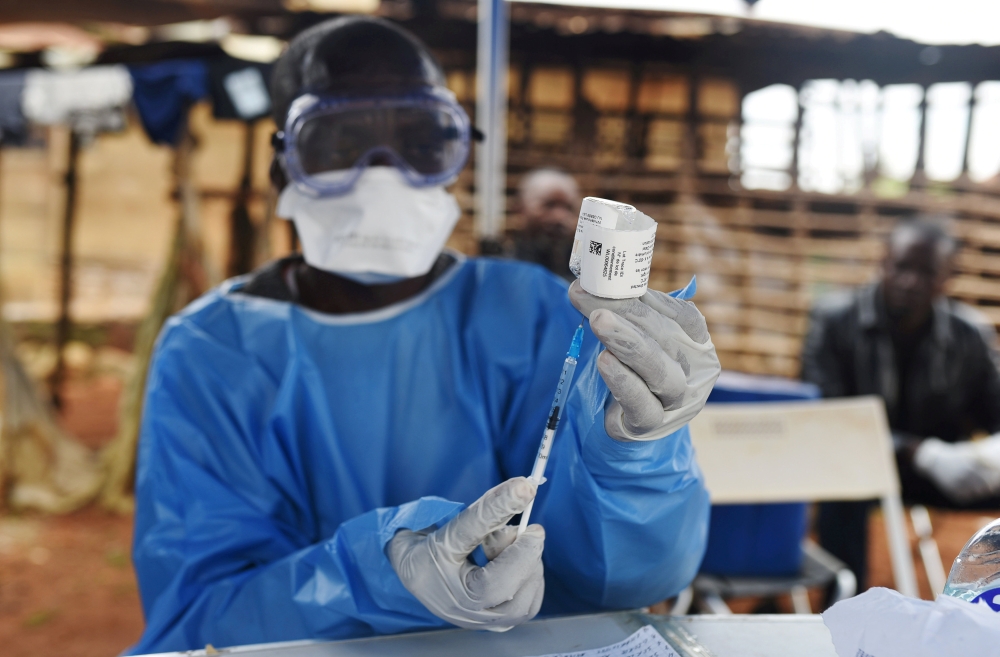 A Congolese health worker prepares to administer Ebola vaccine, outside the house of a victim who died from Ebola in the village of Mangina in North Kivu province of the Democratic Republic of Congo, August 18, 2018. Reuters/Olivia Acland