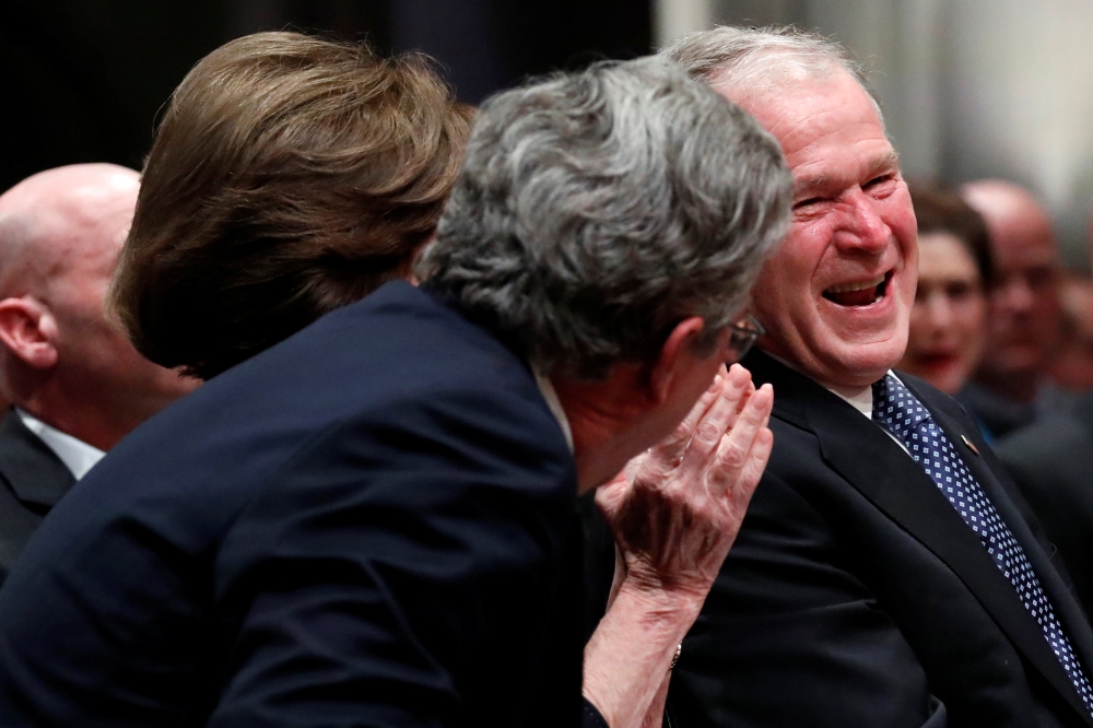 George W. Bush smiles with his brother Jeb Bush at the State Funeral for their father George H.W. Bush, at the National Cathedral, Wednesday, Dec. 5, 2018, in Washington. Alex Brandon/ via Reuters