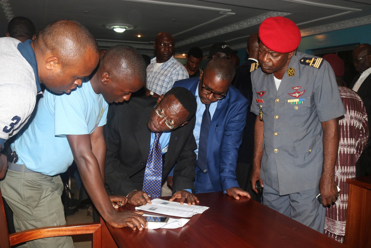 Fontem Afortekaa Neba and Felix Agbor Balla, two Anglophone activists leaders, prepare to sign a document during their release at the prison of Yaounde, Cameroon, September 1, 2017. Reuters