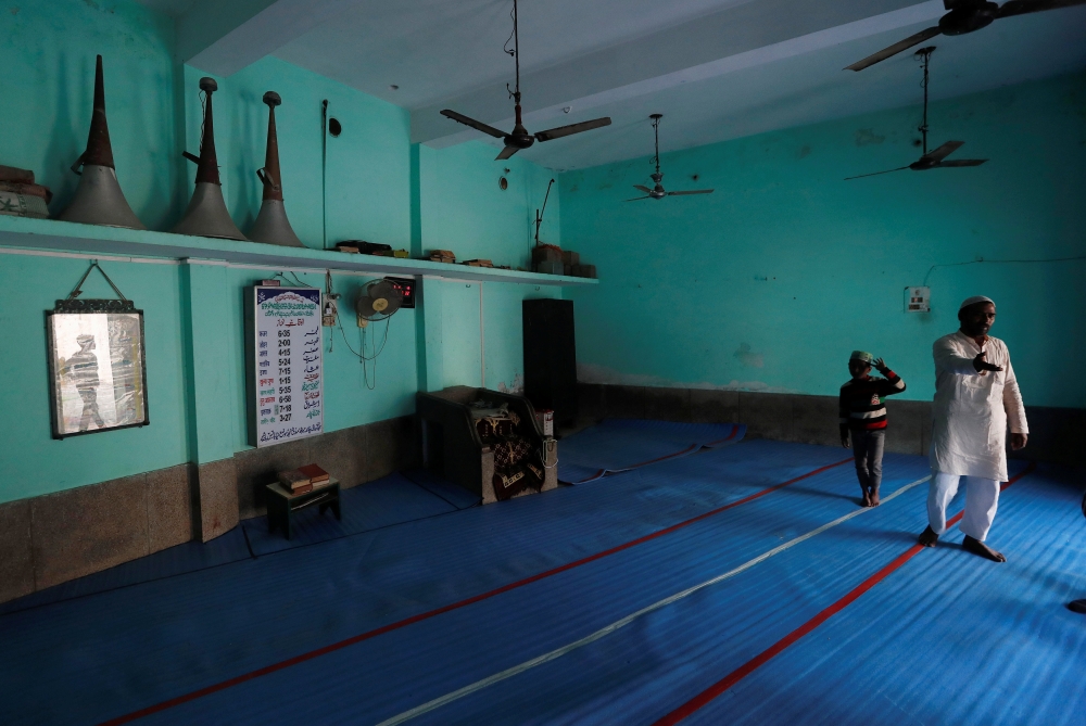 Loudspeakers are seen kept inside a mosque as a Muslim man talks to a reporter in Nayabans village in Bulandshahr district, Uttar Pradesh, India December 5, 2018. Reuters/Adnan Abidi 
