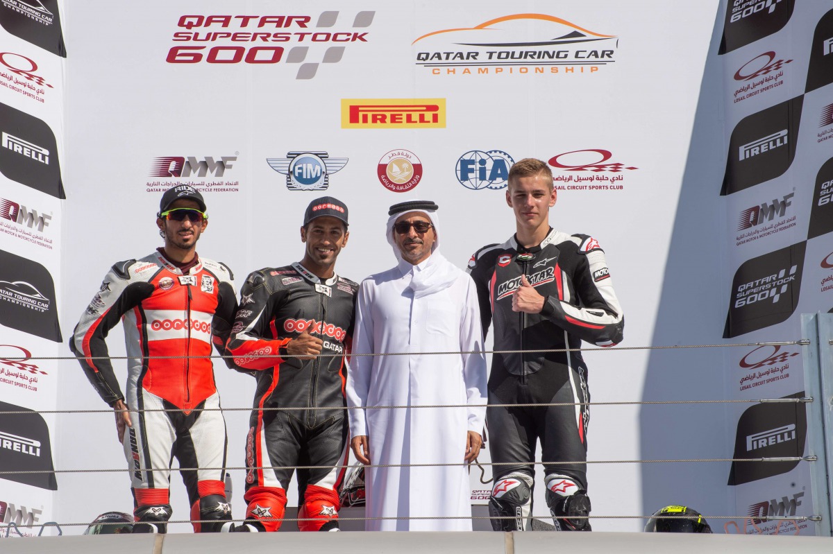 Minister of Culture and Sports H E Salah bin Ghanem Al Ali  poses for a photograph with the podium winners of the Qatar Superstock 600, Race 1, Qatari riders Saeed Al Sulaiti (second, left), Mishal Al Naimi and Hungarian rider Balint Kovacs  (right) durin