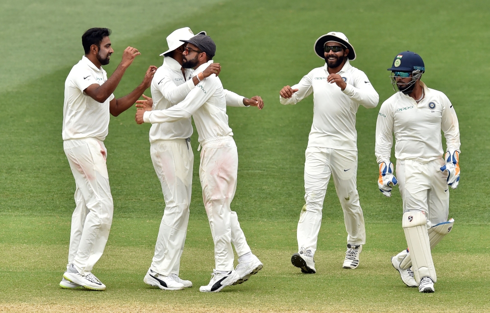 India's captain Virat Kohli (C) cleberates India's victory against Australia in the first Test cricket match at the Adelaide Oval on December 10, 2018. AFP / PETER PARKS  