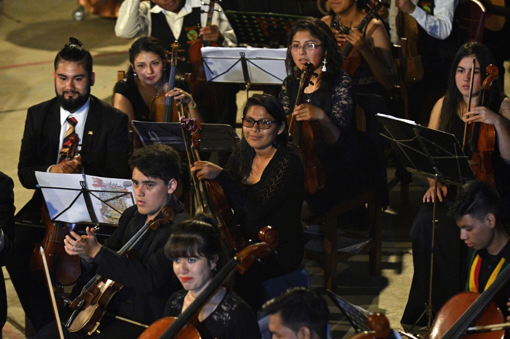 Bolivian coca grower Mariel Chura (C) 21, waits to play the viola during a presentation of the Youth Symphonic Orchestra of Chulumani, some 120 km north of La Paz, on November 21, 2018. Chura joined the Youth Symphonic Orchestra of Chulumani at the age of