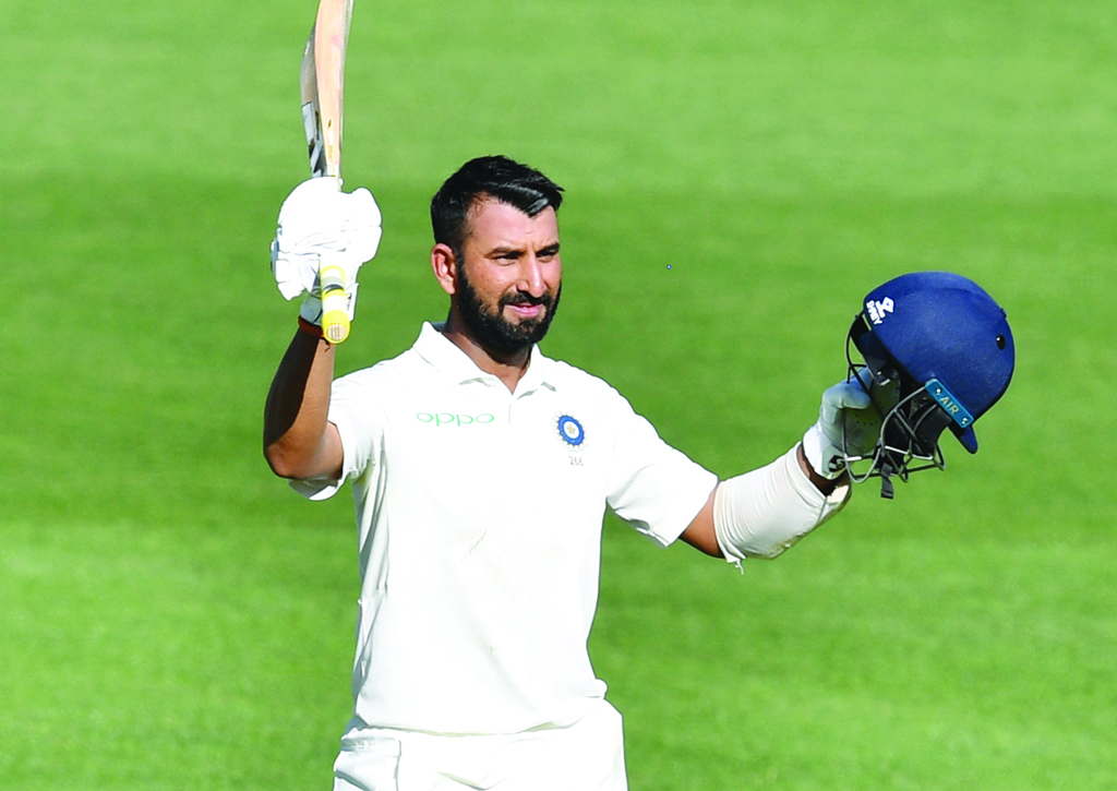 India’s Cheteshwar Pujara celebrates after scoring his century during day one of the first Test at the Adelaide Oval in Adelaide, Australia, in this December 6, 2018, file photo.