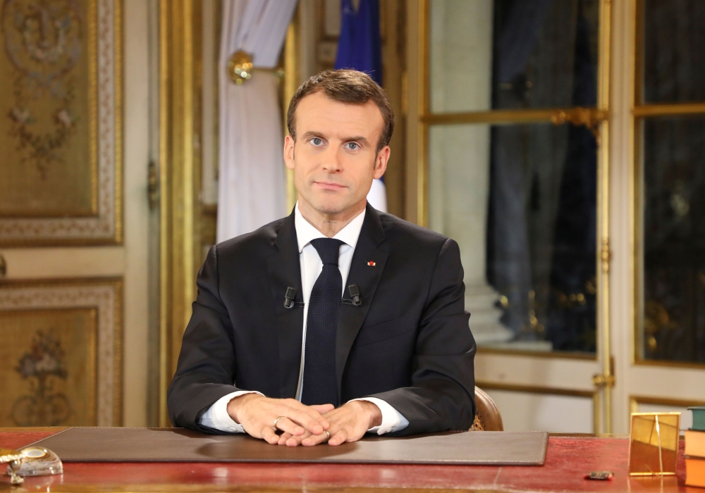 French President Emmanuel Macron speaks during a special address to the nation, his first public comments after four weeks of nationwide 'yellow vest' (gilet jaune) protests, on December 10, 2018, at the Elysee Palace, in Paris. / AFP / LUDOVIC MARIN