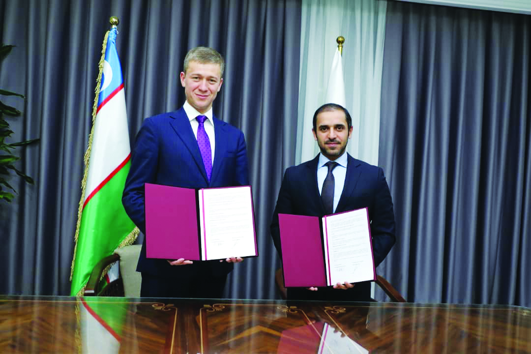 QEF Secretary General Badr Mohammed Al Darwish (right) and MPFU President Bakromjon Gaziev pose for a picture after the signing ceremony. 