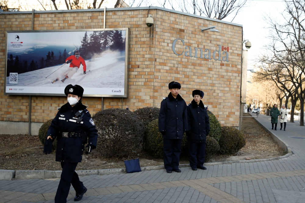 Police keep watch outside the embassy of Canada in Beijing, China, December 12, 2018. REUTERS/Thomas Peter