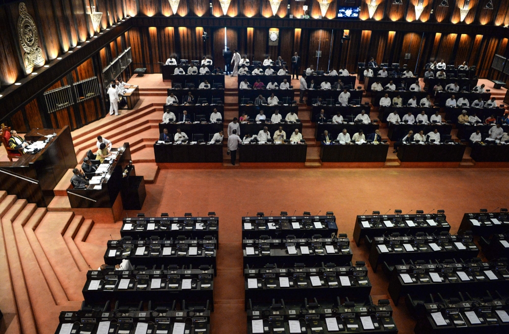Members of parliament attend a parliament session at Sri Lanka's parliament hall in Colombo on December 12, 2018.  AFP / LAKRUWAN WANNIARACHCHI