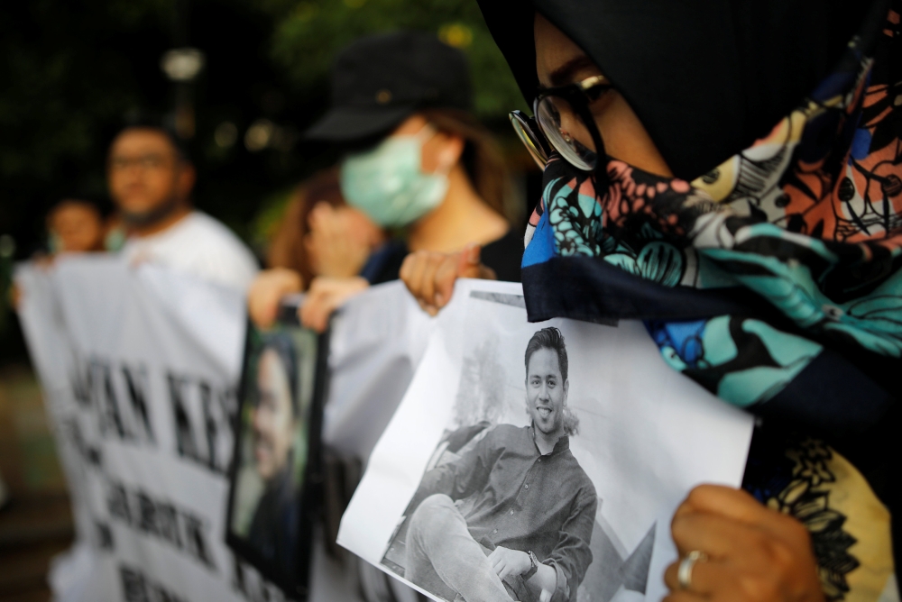 A woman holds a picture of a relative, one of the 189 people killed in a Lion Air plane crash, during a rally calling for Lion Air to put safety over profit and for Indonesian President Joko Widodo to ensure all remains were recovered, in Jakarta, Indones