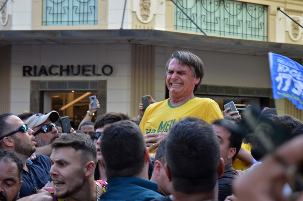 Brazilian right-wing presidential candidate Jair Bolsonaro gestures after being stabbed in the stomach during a campaign rally in Juiz de Fora, Minas Gerais State, in southern Brazil, on September 6, 2018.
