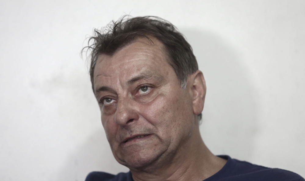 In this file photo taken on October 20, 2017 Italian ultra-leftist activist Cesare Battisti gestures during an interview with AFP in Cananeia, Sao Paulo state, Brazil. / AFP / Miguel SCHINCARIOL 