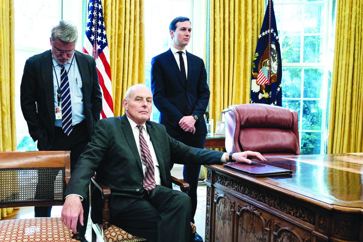 White House communications director Bill Shine (L), White House Chief of Staff John Kelly (C), and Senior Advisor Jared Kushner in Oval Office on December 11, 2018.  AFP / Brendan Smialowski

