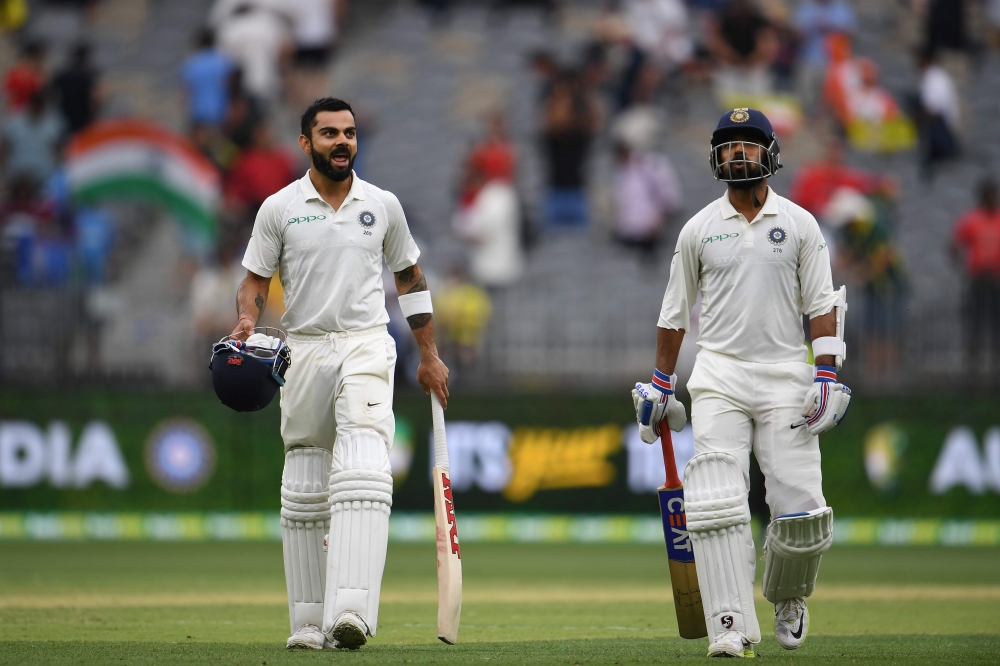 India's batsmen Ajinkya Rahane (R) and Virat Kohli walk back to the dressing room at the end of day two of the second Test cricket match between Australia and India in Perth on December 15, 2018.(AFP / WILLIAM WEST)