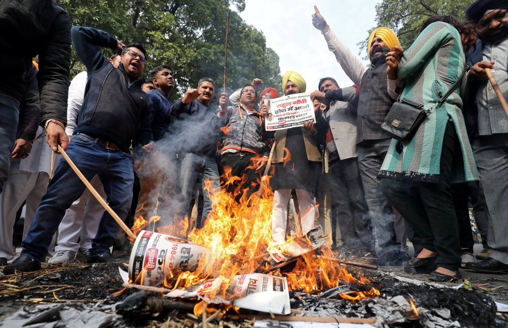 People burn placards and effigies of India's main opposition Congress party's leaders Sajjan Kumar and Kamal Nath during a protest near Congress party's headquarters in New Delhi, India, December 17, 2018. REUTERS/Anushree Fadnavis