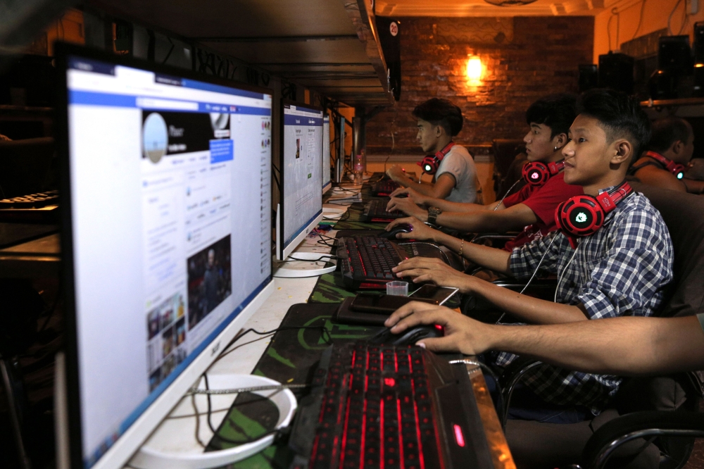 This picture taken on December 18, 2018 shows Myanmar youths browsing their Facebook page at an internet shop in Yangon. / AFP / Sai Aung MAIN 