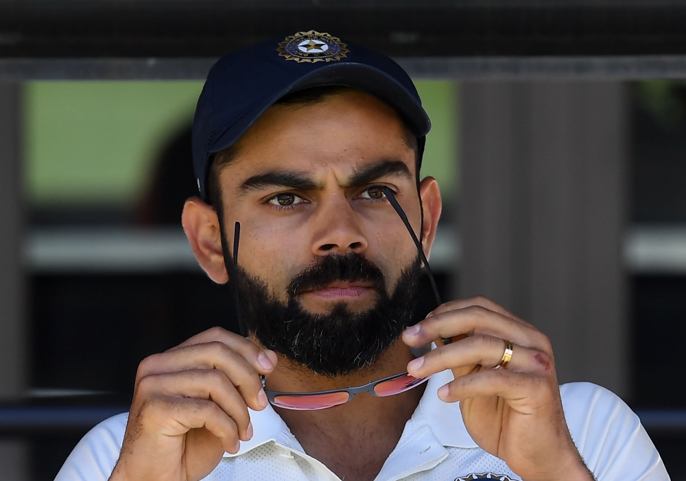 India's captain Virat Kohli (C) sits on the players bench at the end of second Test cricket match between Australia and India in Perth on December 18, 2018. / AFP / WILLIAM WEST / 