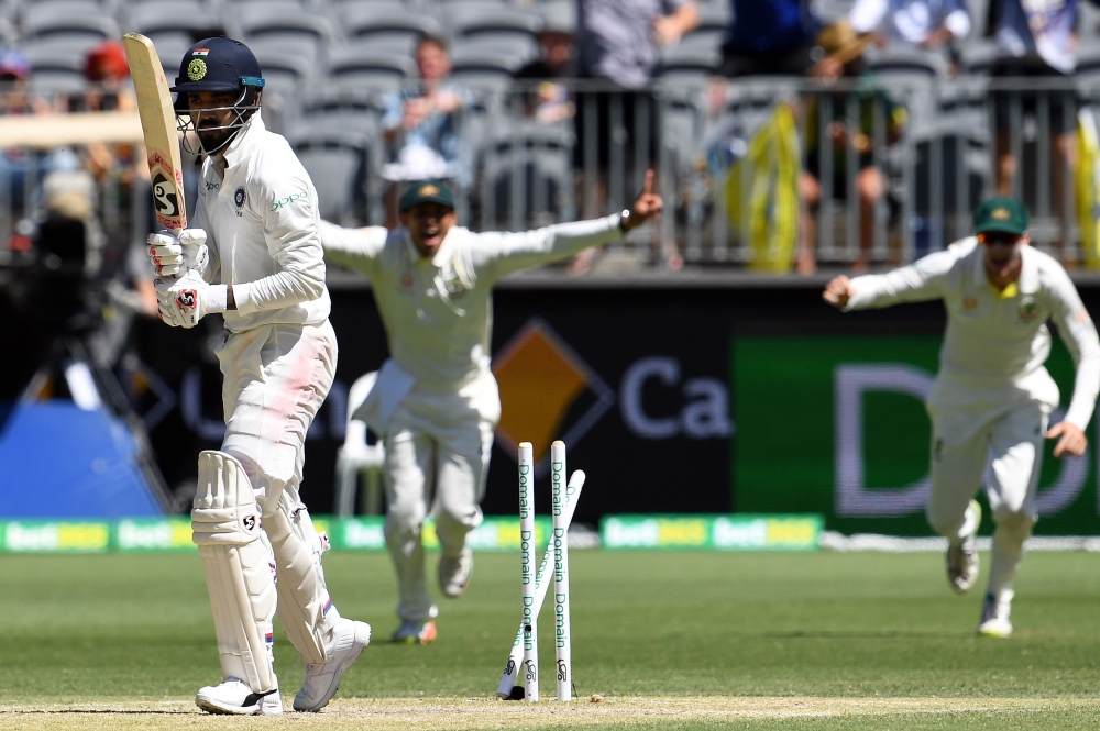 India's batsman Lokesh Rahul (L) is clean bowled by Australia's paceman Mitchell Starc during day four of the second Test cricket match between Australia and India in Perth on December 17, 2018. (AFP / WILLIAM WEST)