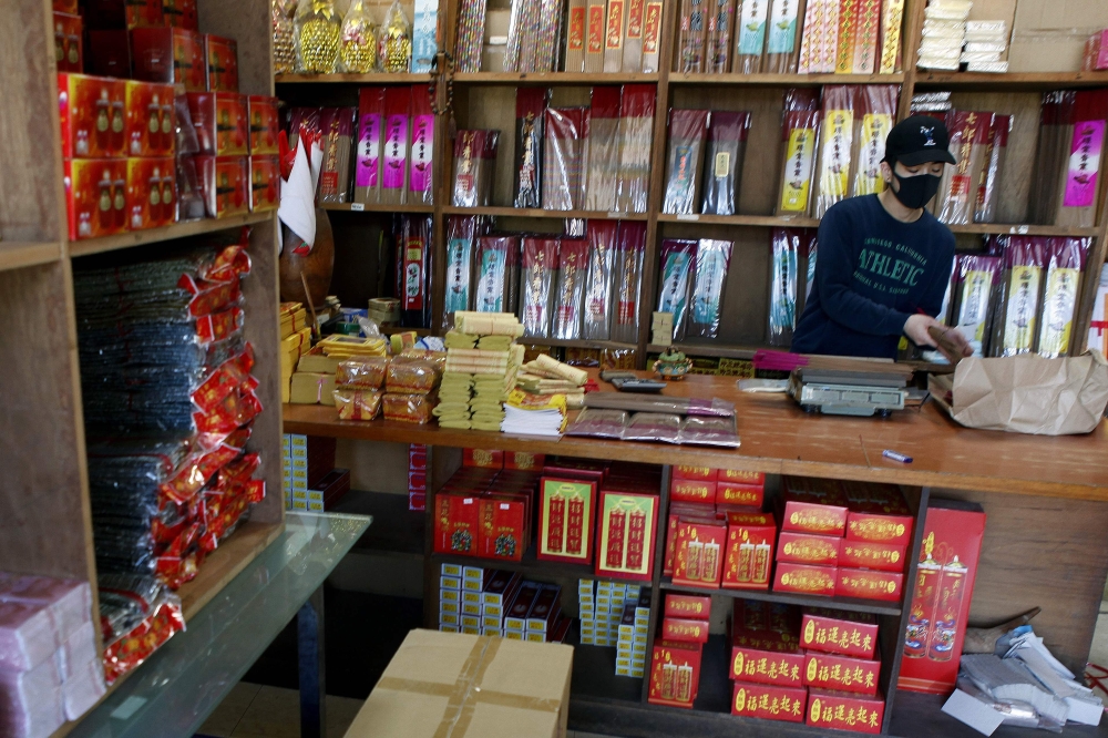 Lin Chin-hsiang, the young man who damaged three Ferraris in a single crash, works at his family’s shop selling incense and gold paper money in Taipei on December 20, 2018. AFP