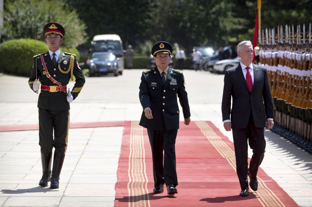 Chinese Defense Minister Wei Fenghe and US Defense Secretary Jim Mattis review an honor guard at the Bayi Building in Beijing, June 27, 2018/ Mark Schiefelbein/via Reuters