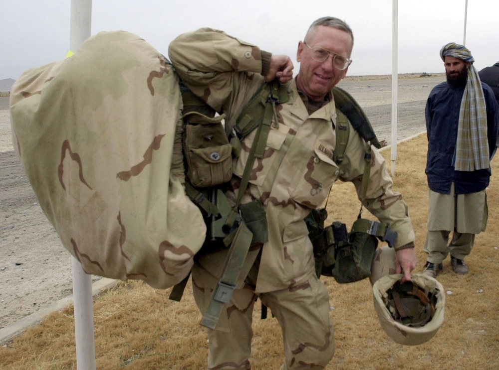 Brigadier General James Mattis carries his packs into the Kandahar International Airport, where he was to set up operations after arriving December 14, 2001. Reuters/Dave Martin
 

