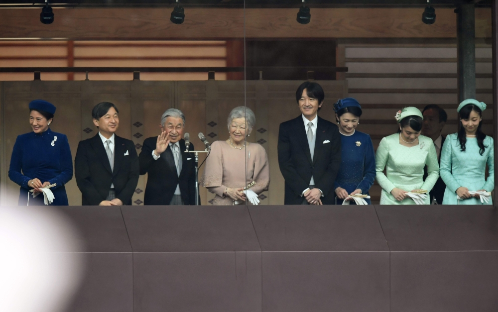Japan's Emperor Akihito (3rd L) waves during his birthday public appearance with other members of the Imperial family including Crown Princess Masako (L), Crown Prince Naruhito (2nd L), (4th L to R) Empress Michiko, Prince Akishino, Princess Kiko, Princes