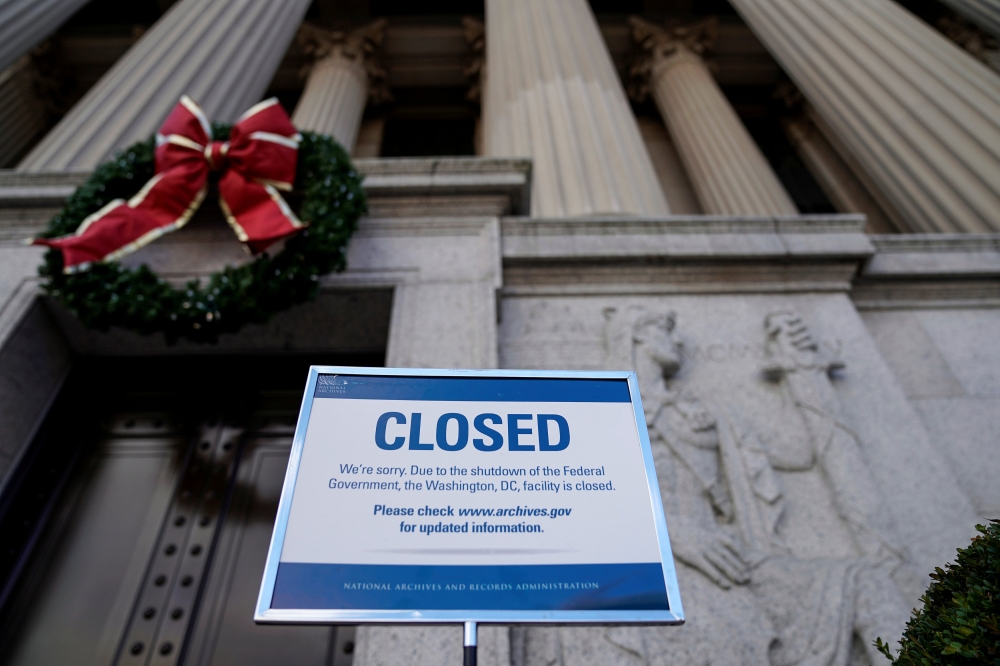 A sign declares the National Archive is closed due to a partial federal government shutdown in Washington, U.S., December 22, 2018. REUTERS/Joshua Roberts 