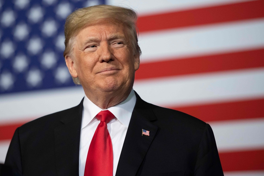 FILE PHOTO:US President Donald Trump  / AFP / Jim WATSON