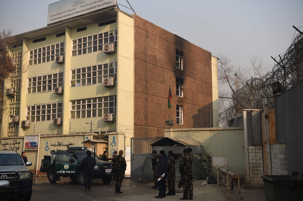 Afghan security forces stand guards at the Ministry of Public Works a day after a deadly militant attack in Kabul on December 25, 2018.   AFP / WAKIL KOHSAR